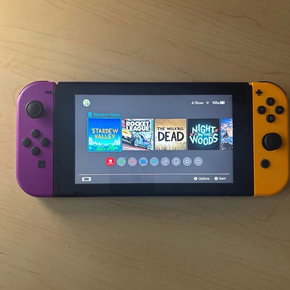 Nintendo Switch with Purple and Yellow Joy-Con with 7 games